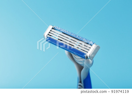 Shaving machine for the face on a blue background top view free space Shaving machine for the face on a blue background top view free space 91974119