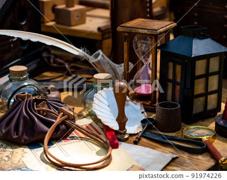 scribe's table with goose feather pen, hourglass 91974226