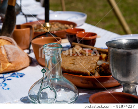 table set for outdoor medieval dining in a park during a festival 91974227