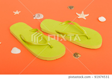 Beach accessories. Flip flops and starfish on colored background. Top view Mock up with copy space Beach accessories. Flip flops and starfish on colored background. Top view Mock up with copy space 91974531