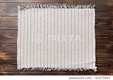Top view of grey tablecloth for food on wooden background. Empty space for your design Top view of grey tablecloth for food on wooden background. Empty space for your design 91975607