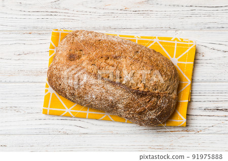 Fresh Homemade Whole Wheat Bread. bread on napkin on rustic background, fresh bread top view 91975888