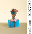 Ice cream melting in a badminton shuttlecock on a blue roller pedestal in front of a yellow and brown background. 91977039
