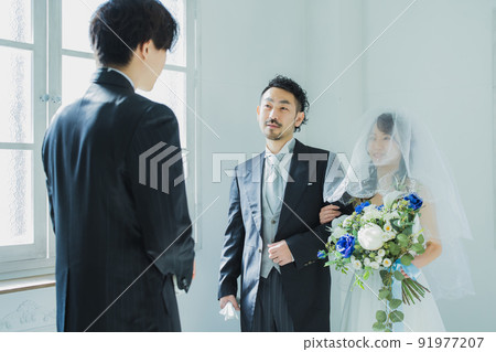 Image of a bride walking with her arms crossed with her father Image of a bride walking with her arms crossed with her father 91977207