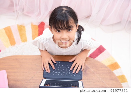 Elementary school girl learning tablet in the children's room 91977851