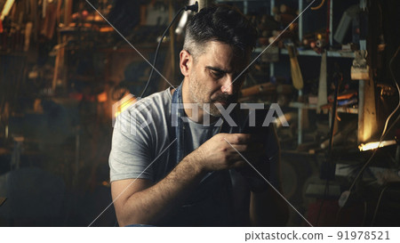 Man with smartphone resting after work 91978521