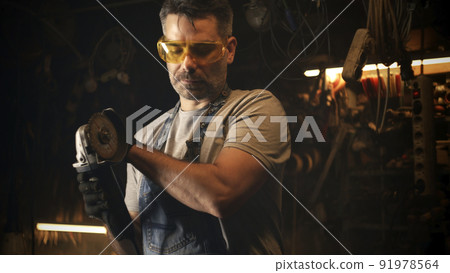 Man making barbecue grill in free time Man making barbecue grill in free time 91978564