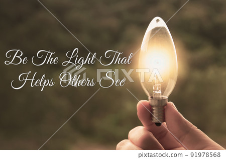 Motivational and Inspirational quote - Be the light that helps others see. With light bulb in vintage color background. Motivational and Inspirational quote - Be the light that helps others see. With light bulb in vintage color background. 91978568