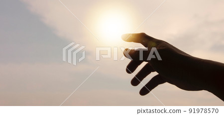 Hands reaching out to bright sky with copy space for ideas or text. 91978570