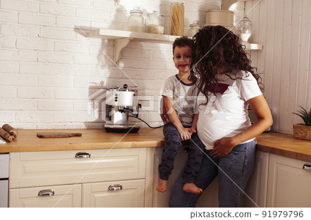 young pretty african american mother with little cute son on kitchen in morning preparing breakfast, lifestyle people concept close up 91979796