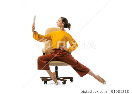 Portrait of young pretty girl, office worker in stylish attire dancing on armchair isolated over white studio background. Concept of beauty, business, ballet, art, dance style Portrait of young pretty girl, office worker in stylish attire dancing on armchair isolated over white studio background. Concept of beauty, business, ballet, art, dance style 91981218