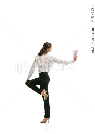 Young business woman wearing business style outfit in motion isolated on white background. Business, start-up, open-space, professional occupation concept. Young business woman wearing business style outfit in motion isolated on white background. Business, start-up, open-space, professional occupation concept. 91981262