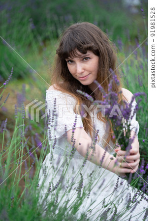 A smiling woman with lavender A smiling woman with lavender 91981528