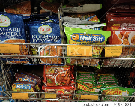 SELANGOR, MALAYSIA -JULY 3, 2021: Selective focused on various types of spice powders that have been packed in commercial packs. Sorted by brand and type. Labeled with a price tag. 91981821