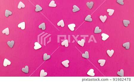 Close-up of a postcard, many small hearts. Festive abstract background. 91982478
