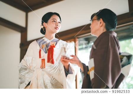 Shiromuku bride and senior in kimono Shiromuku bride and senior in kimono 91982533