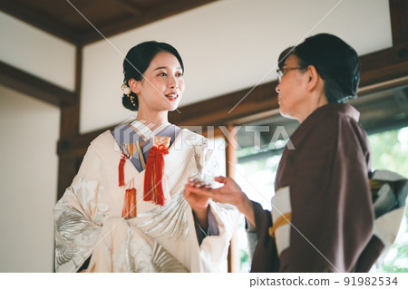 Shiromuku bride and senior in kimono Shiromuku bride and senior in kimono 91982534