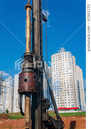 machine for drilling deep piles against the backdrop of residential areas machine for drilling deep piles against the backdrop of residential areas 91983155