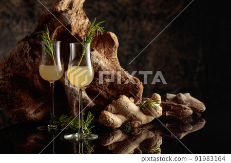 Ginger liquor with a rosemary branch. 91983164