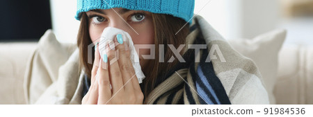 Sick person blowing running nose and sneezing in tissue stay at home on self isolation 91984536