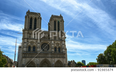 Paris, France. June 2022. Nice view of the Notre Dame facade. The crane of the restoration site is visible after the great fire that damaged the cathedral. Paris, France. June 2022. Nice view of the Notre Dame facade. The crane of the restoration site is visible after the great fire that damaged the cathedral. 91985874