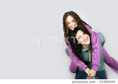 Studio Portrait of happy family mom and teenager daughter spend time together 91986084
