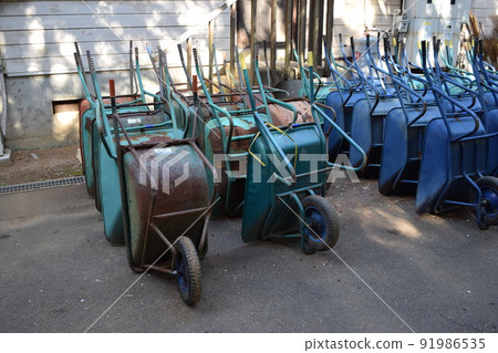 Multiple wheelbarrows leaning against Multiple wheelbarrows leaning against 91986535