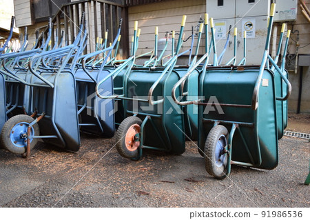 Multiple wheelbarrows leaning against Multiple wheelbarrows leaning against 91986536
