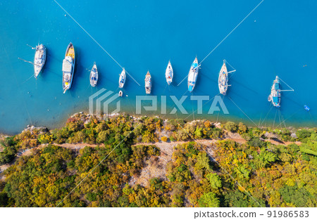 Aerial view of beautiful yachts and boats on the sea at sunset Aerial view of beautiful yachts and boats on the sea at sunset 91986583
