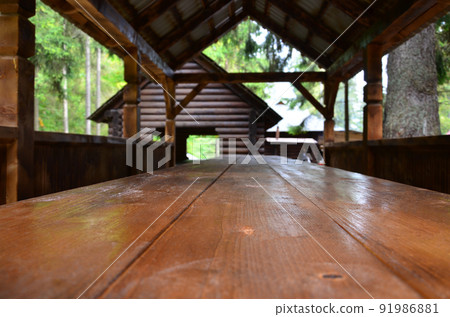 Interior of a wooden arbor handmade from dark wood in the woodland 91986881