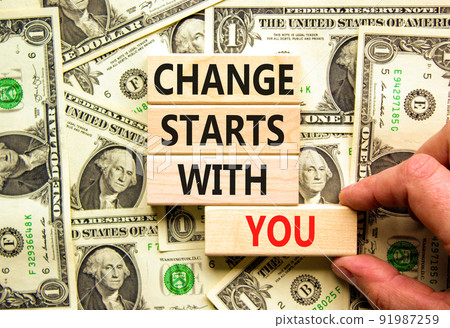 Change starts with you symbol. Concept words Change starts with you on wooden blocks on a beautiful background from dollar bills. Businessman hand. Business motivational change starts with you concept Change starts with you symbol. Concept words Change starts with you on wooden blocks on a beautiful background from dollar bills. Businessman hand. Business motivational change starts with you concept 91987259