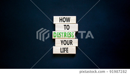 Destress your life symbol. Concept words How to destress your life on wooden blocks. Beautiful black table black background. Copy space. Psychological business destress your life concept. Copy space. 91987282