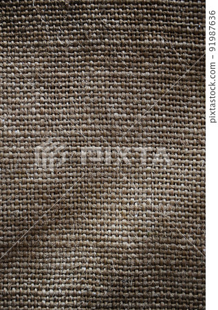 The texture of a very old brown sack cloth. Retro texture with canvas material. Background image with copy space The texture of a very old brown sack cloth. Retro texture with canvas material. Background image with copy space 91987636
