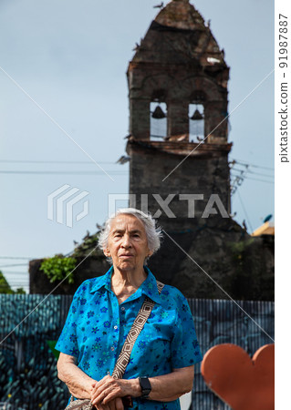 Senior woman at the ruins of the Convent of Santo Domingo in the city of Mariquita Senior woman at the ruins of the Convent of Santo Domingo in the city of Mariquita 91987887