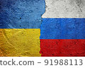 Russia vs Ukraine - Cracked concrete wall painted with a Ukrainian flag on the left and a Russian flag on the right stock photo 91988113