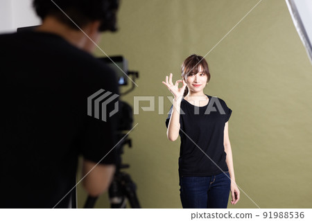 Photographers and assistants shooting in the studio Photographers and assistants shooting in the studio 91988536