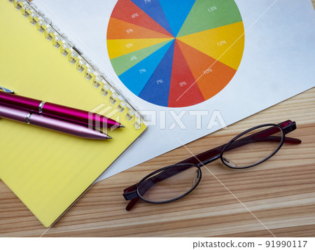 Business image of graphs, notebooks, glasses (female) 91990117