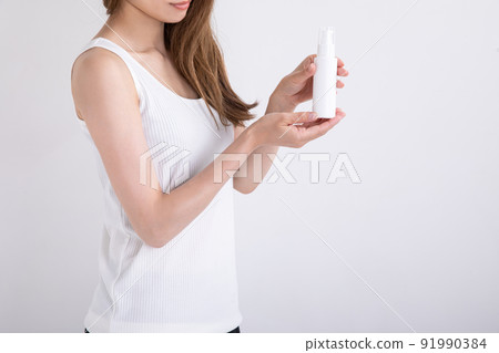 Woman with a spray bottle spray Woman with a spray bottle spray 91990384