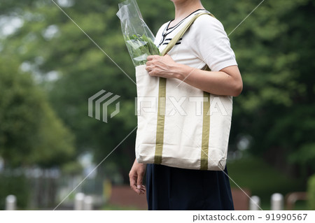 Hands of a woman with an eco bag Hands of a woman with an eco bag 91990567