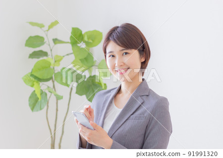 Business woman using a smartphone Business woman using a smartphone 91991320