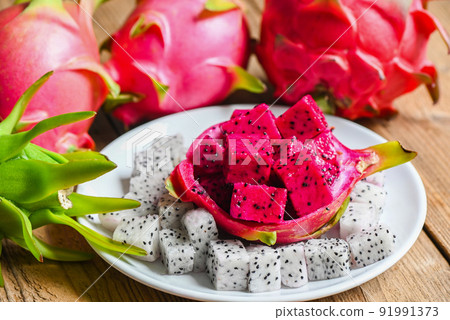 fresh white and red purple dragon fruit tropical in the asian thailand healthy fruit concept, dragon fruit slice on white plate with pitahaya background fresh white and red purple dragon fruit tropical in the asian thailand healthy fruit concept, dragon fruit slice on white plate with pitahaya background 91991373