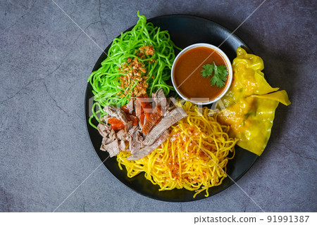 Jade noodle and yellow noodles Asian Thailand food , roasted duck with jade noodle and pork dumplings on plate and duck sauce , green noodles Chinese food Jade noodle and yellow noodles Asian Thailand food , roasted duck with jade noodle and pork dumplings on plate and duck sauce , green noodles Chinese food 91991387