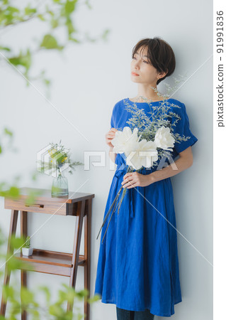 A woman in a blue dress A woman in a blue dress 91991836