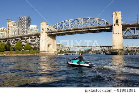 Adventurous Caucasian Woman on Water Scooter riding in the Ocean. 91991891