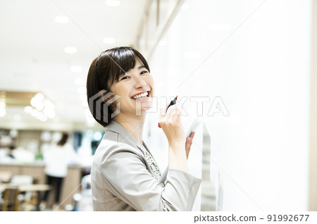 Business women's office presentation seminar looking at the camera Business women's office presentation seminar looking at the camera 91992677