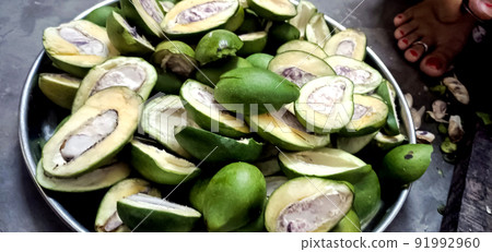 Slices of green mango with raw mango for pickling.Asian cuisine. 91992960