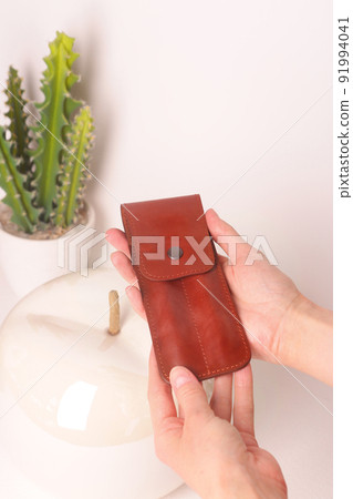 red leather pen case for two pen closeup photo on white interior background 91994041