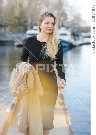 young blond slavic woman with long hair street portrait with glasses on marina boat background young blond slavic woman with long hair street portrait with glasses on marina boat background 91994073