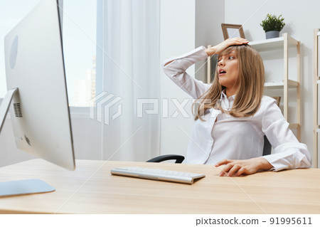 Shocked adorable blonde businesswoman worker touch head have headache thinking of problem solution in light modern office. Scared employee work on computer online making big mistake. Copy space Shocked adorable blonde businesswoman worker touch head have headache thinking of problem solution in light modern office. Scared employee work on computer online making big mistake. Copy space 91995611