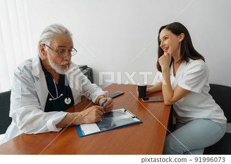 Doctor and nurse talking during a break in the medical office in clinic 91996073
